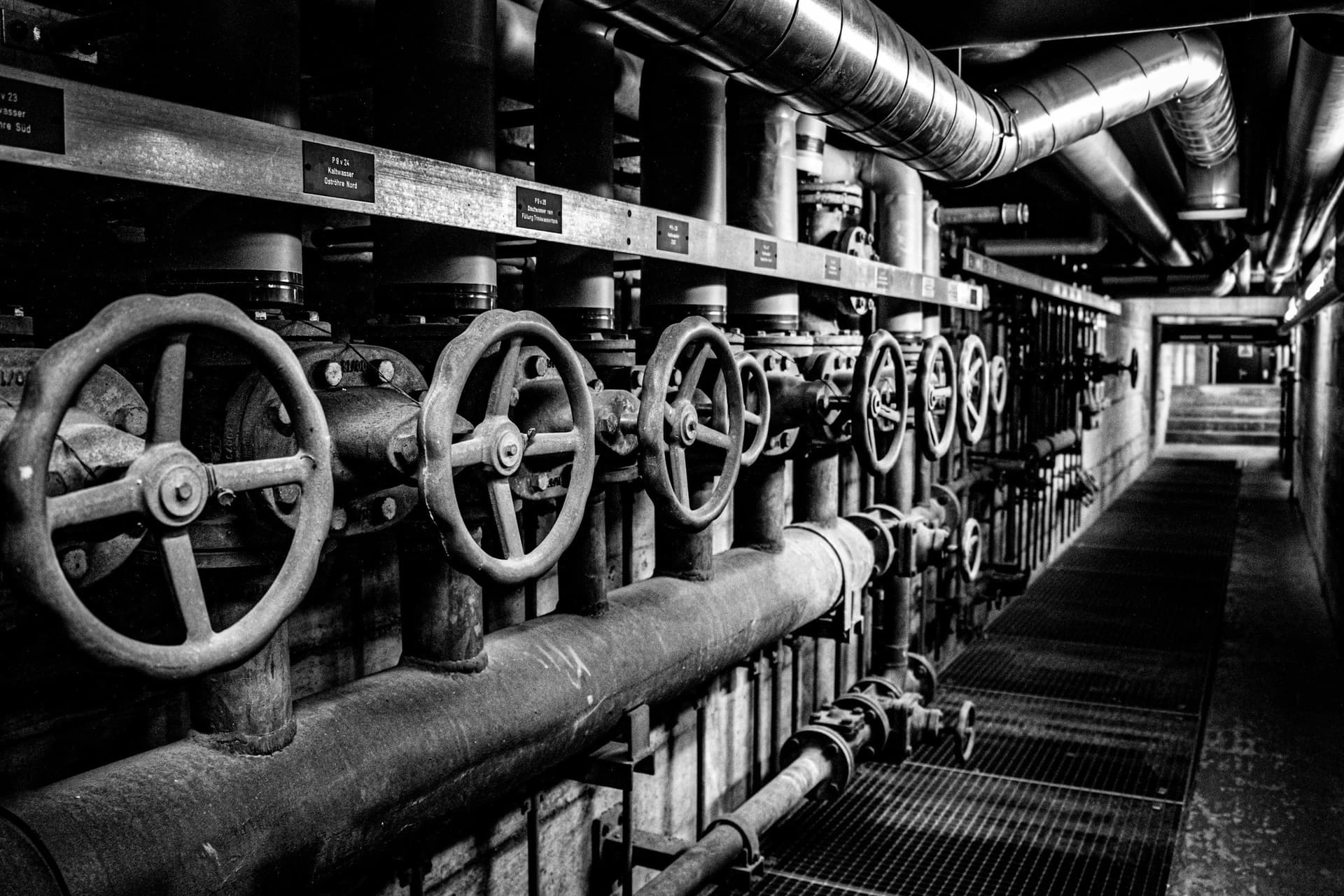 Industrial valves and piping in a mechanical corridor